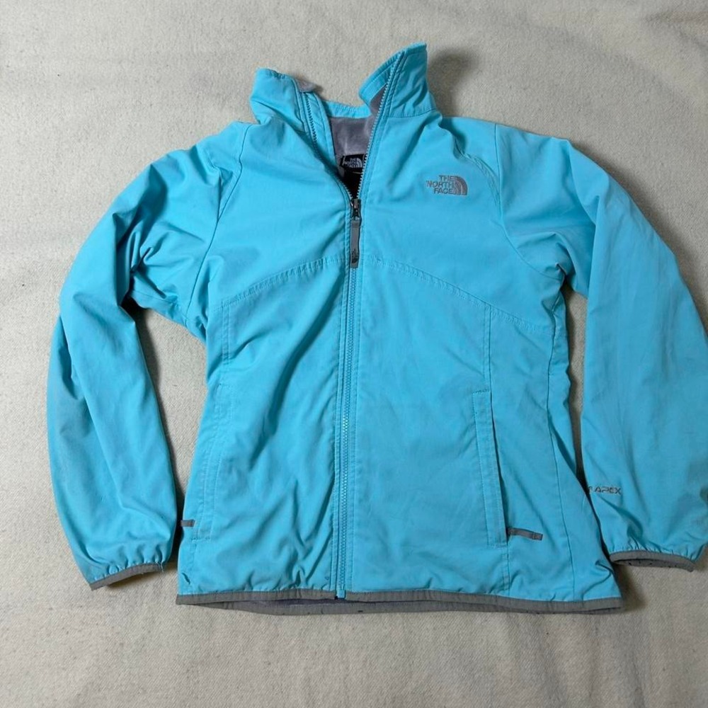 The North Face lightweight blue jacket with zipper‎ pockets and adjustable waist